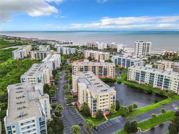 Aerial view of oceanfront condos with resort-style amenities and lush landscaping at 5300 S Atlantic Ave # 9-403, New Smyrna Beach, FL 32169