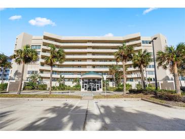Stunning condo building featuring beautiful landscaping with palm trees and plenty of parking spaces at 4621 S Atlantic Ave # 7101, Ponce Inlet, FL 32127
