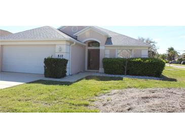 Charming single-story home with a well-manicured lawn and attached two-car garage at 537 Coral Trace Blvd, Edgewater, FL 32132