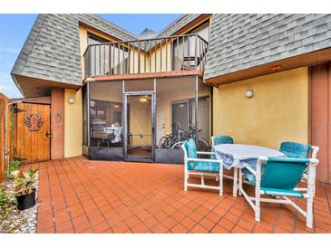 Charming patio area with a screened-in porch, perfect for outdoor dining and relaxation at 116 Cedar Dunes Dr, New Smyrna Beach, FL 32169