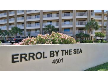 Exterior shot of Errol By The Sea condominiums, boasting balconies, palm trees, and lush landscaping at 4501 S Atlantic Ave # 1150, New Smyrna Beach, FL 32169
