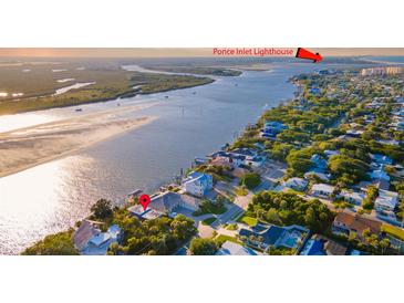 Aerial view showcasing a waterfront home near Ponce Inlet Lighthouse, with beach access nearby at 1324 N Peninsula Ave, New Smyrna Beach, FL 32169