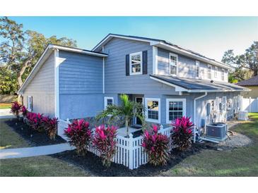 Two-story house with gray siding, white trim, and landscaping at 2202 Venetian Ave, Belle Isle, FL 32809