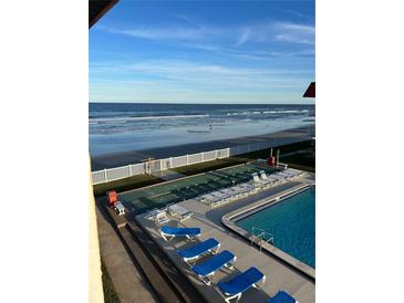 Stunning oceanfront view with pool and patio area at 3801 S Atlantic Ave # 304, New Smyrna Beach, FL 32169