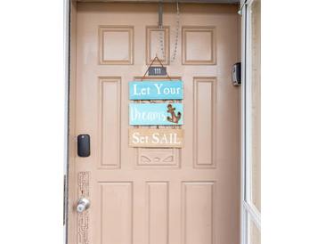 Inviting front door with beach-themed decor at 4155 S Atlantic Ave # 111, New Smyrna Beach, FL 32169