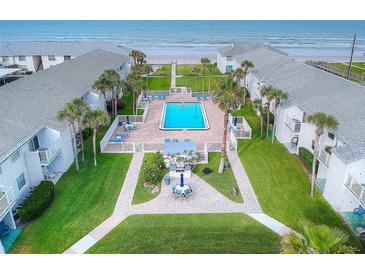 Aerial view of community pool, beach access, and oceanfront location at 4225 S Atlantic Ave # 144, New Smyrna Beach, FL 32169