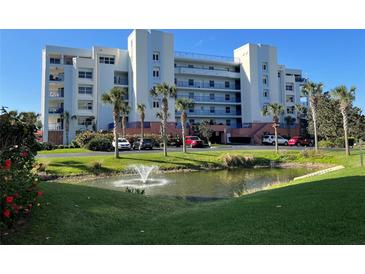 Ocean Surf condo building with pond and landscaping at 5300 S Atlantic Ave # 16201, New Smyrna Beach, FL 32169