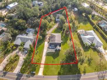 Aerial view of house, showcasing the property and surrounding landscape at 997 Sugar Mill Dr, New Smyrna Beach, FL 32168