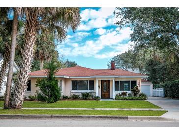 Charming single-story house with red tile roof, landscaping, and a spacious yard at 1207 Magnolia St, New Smyrna Beach, FL 32168