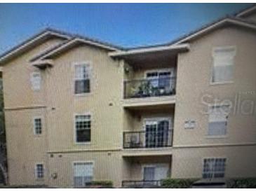 Tan three-story building with balconies and multiple windows at 126 Vista Verdi Cir # 204, Lake Mary, FL 32746