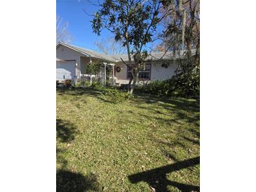 Single-story home with a spacious yard and mature trees at 2421 Silver Palm Dr, Edgewater, FL 32141