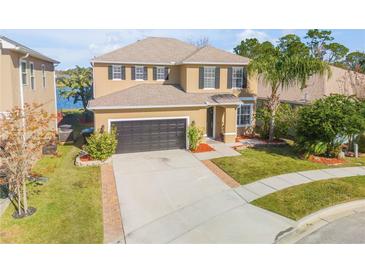 Two-story house with a large driveway and landscaped yard at 2707 Atlantis Dr, New Smyrna Beach, FL 32168