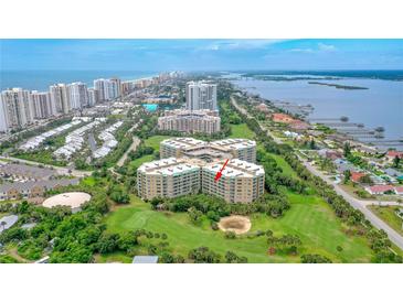 Aerial view of condo building showcasing ocean views and lush landscaping at 4 Oceans West Blvd # 502B, Daytona Beach, FL 32118