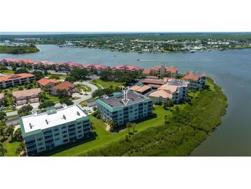 Stunning aerial view of waterfront condos boasting lush greenery and access to the beautiful waterways at 432 Bouchelle Dr # 403, New Smyrna Beach, FL 32169