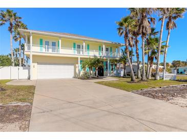 Two-story house with light yellow walls, white trim, and teal shutters at 708 Ocean Ave, New Smyrna Beach, FL 32169