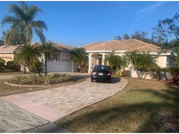 One-story home with tile roof, driveway, and lush landscaping at 987 Mori Ct, Port Orange, FL 32127
