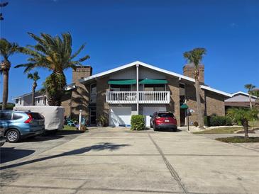 Spacious condo with a private balcony, attached garage, and ample parking for residents and guests at 113 Lagoon Ct, New Smyrna Beach, FL 32169