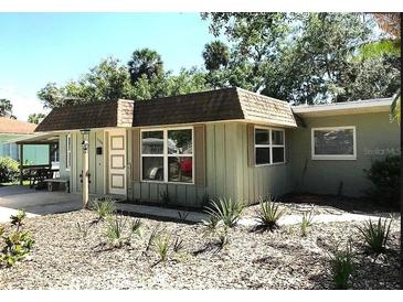 Ranch style home with green exterior, mature landscaping, and a spacious yard at 1506 Palmetto St, New Smyrna Beach, FL 32168