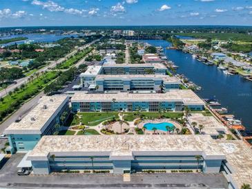 Aerial view of waterfront community with pool and lush landscaping at 325 Causeway # E 203, New Smyrna Beach, FL 32169