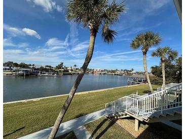 Stunning waterfront view with palm trees and boats at 335 N Causeway # H23, New Smyrna Beach, FL 32169