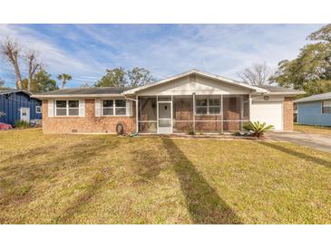 Brick ranch home with screened porch and spacious yard at 413 Division Ave, Ormond Beach, FL 32174