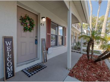 Inviting front entrance with a wreath, charming welcome mat and home sweet home sign at 980 Canal View Blvd # C7, Port Orange, FL 32129