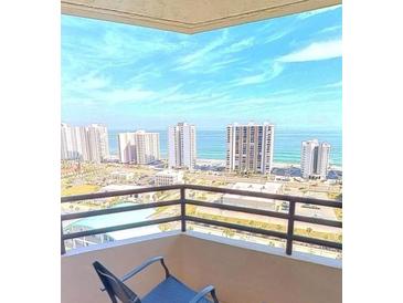 Enjoy beautiful ocean and city views from this condo balcony with comfortable seating and a sunny outlook at 1 Oceans W Blvd # 22A3, Daytona Beach, FL 32118