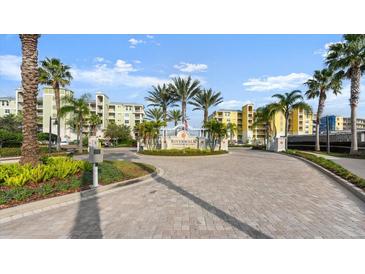 Welcoming community entrance, showcasing lush landscaping and manicured grounds under a bright, sunny sky at 2 Riverwalk Dr # 402, New Smyrna Beach, FL 32169