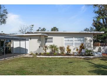 Charming single-story home with manicured front lawn and carport in a residential neighborhood at 229 Columbus Ave, Daytona Beach, FL 32118