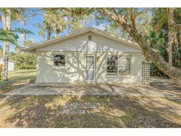 Ranch style home with a white exterior and mature landscaping at 2515 Fairfax Ave, New Smyrna Beach, FL 32168