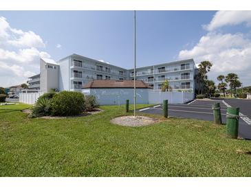 Beautiful light blue building with well maintained landscaping and clearly marked parking spots at 3700 S Atlantic Ave # 108, New Smyrna Beach, FL 32169