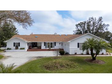 Charming single-story home with well-maintained landscaping and a welcoming front entrance at 958 Beach Fern Ct, New Smyrna Beach, FL 32168