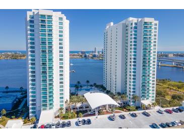 Stunning aerial view of two modern high-rise condo buildings with blue balconies overlooking the water at 231 Riverside Dr # 1509-1, Holly Hill, FL 32117