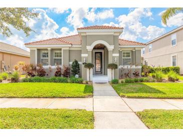 Charming home featuring a tiled roof, manicured lawn, and inviting front entrance at 3456 Pegaso Ave, New Smyrna Beach, FL 32168