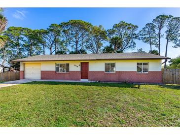 Charming single-story home with a well-maintained lawn and a brick-accented facade at 1039 Beulah Dr, Edgewater, FL 32132