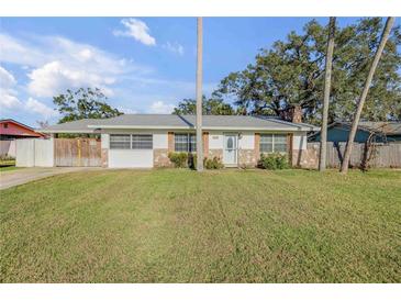 Charming single-story home with stone accents, well-maintained lawn, and a welcoming entrance at 1855 Needle Palm Dr, Edgewater, FL 32141