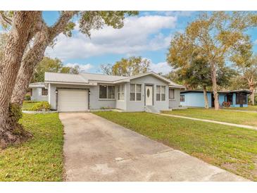 Charming single-story home featuring a well-maintained lawn, metal roof and an attached one car garage at 254 Tanner St, New Smyrna Beach, FL 32168