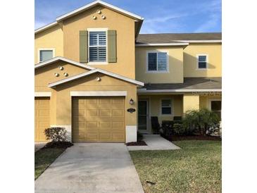 Two-story home featuring a one car garage, neutral paint, and simple landscaping at 2669 Sicily Dr, New Smyrna Beach, FL 32168