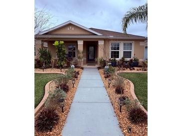 Charming single-story home with a meticulously landscaped front yard and walkway at 3368 Tuscano Ne Ave, New Smyrna Beach, FL 32168