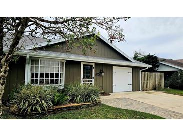 Charming home featuring a well-maintained lawn, a bay window, and an attached one-car garage at 45 Sandra Cir, New Smyrna Beach, FL 32168