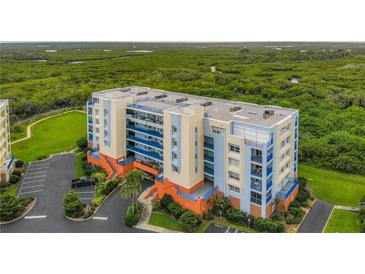 Beautiful condominium building with manicured landscaping and ample parking at 5300 S Atlantic Ave # 5-407, New Smyrna Beach, FL 32169