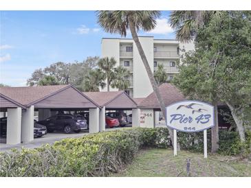 View of building, parking, and sign for Pier 43 in a waterfront community in New Smyrna Beach, Florida at 944 S Peninsula Dr # 5010, Daytona Beach, FL 32118