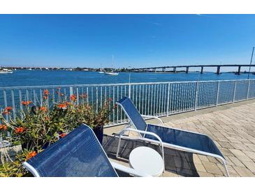 Waterfront patio featuring loungers, and beautiful bay views on a sunny day at 101 N Riverside Dr # 2090, New Smyrna Beach, FL 32168