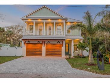 Charming two-story home with a two-car garage and a second story balcony at 213 Cedar Ave, New Smyrna Beach, FL 32169