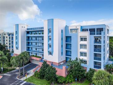 Beautiful building with multiple balconies, well landscaped with palm trees, blue and white design at 5300 S Atlantic Ave # 7-307, New Smyrna Beach, FL 32169