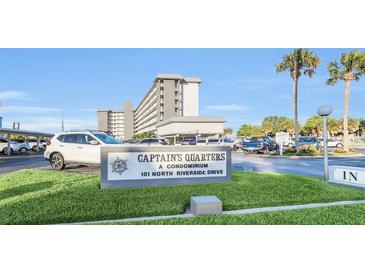 Captain's Quarters condominium complex signage at 101 North Riverside Drive with palm trees in the background at 101 N Riverside Dr # 214, New Smyrna Beach, FL 32169