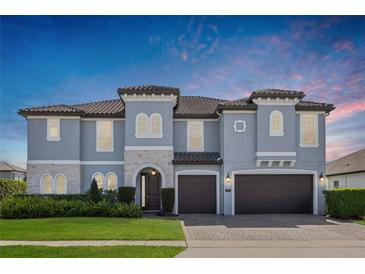 Stunning two-story home with a well-manicured lawn and a three-car garage at 465 White Cotton Cir, Oviedo, FL 32765