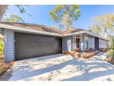 Charming one-story home with a large garage door and appealing curb appeal at 6205 Klondike Dr, Port Orange, FL 32127