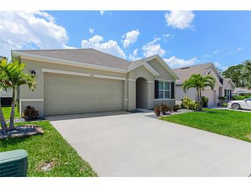 Charming home with a two-car garage, well-manicured lawn, and lovely landscaping at 532 White Coral Ln, New Smyrna Beach, FL 32168