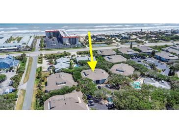 An aerial view of a charming condo complex near the ocean, showcasing nearby beach access and lush landscaping at 4307 Sea Mist Dr # 135, New Smyrna Beach, FL 32169